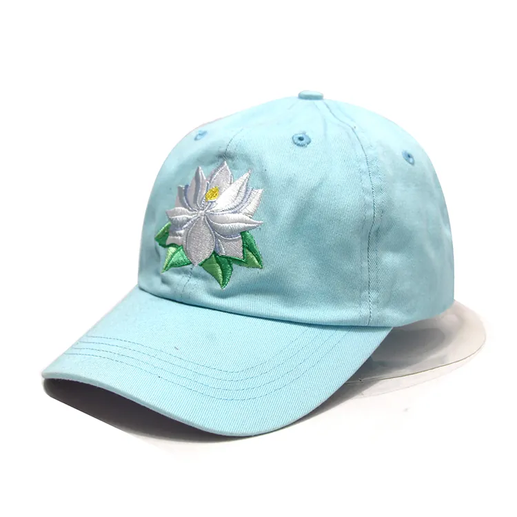 Angled view of a light-blue cap showing its side panel seam beside floral embroidery and a curved brim.