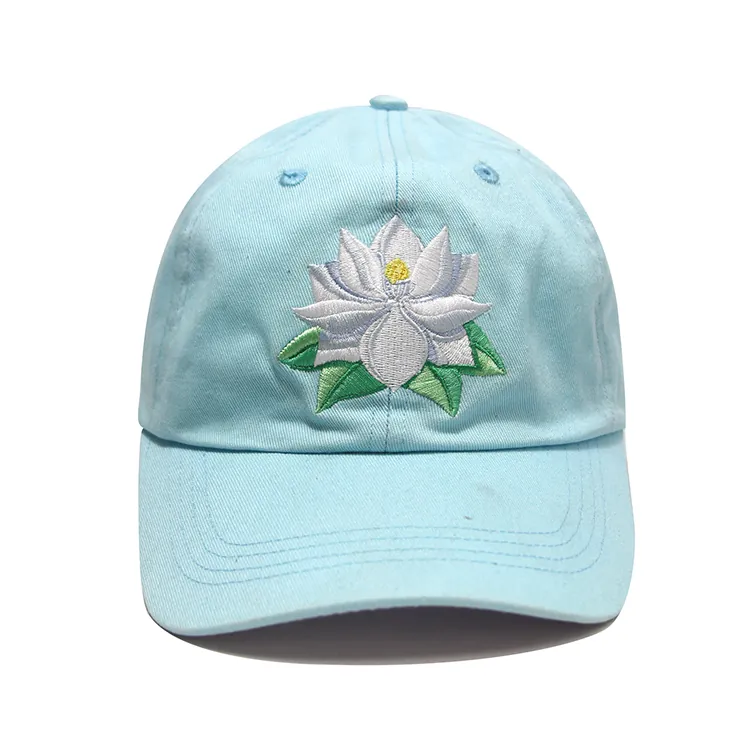 Front view of a light-blue cap with a vertical center seam passing through a floral embroidery design.