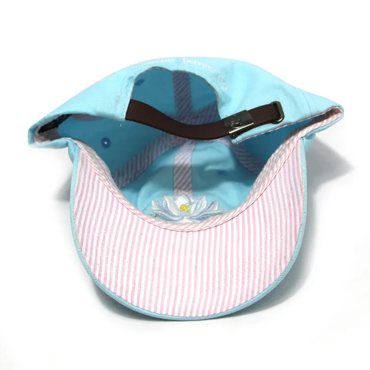 Inside view of a light-blue cap showing covered crown seams, rear strap and striped underside of the brim.