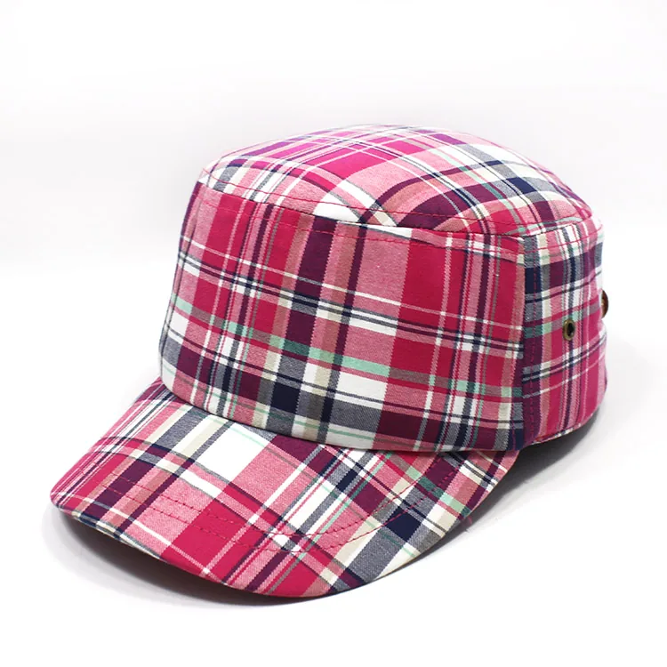 Three-quarter view of a pink, red, navy and white plaid-like flat-top cap with pattern across its crown and brim.