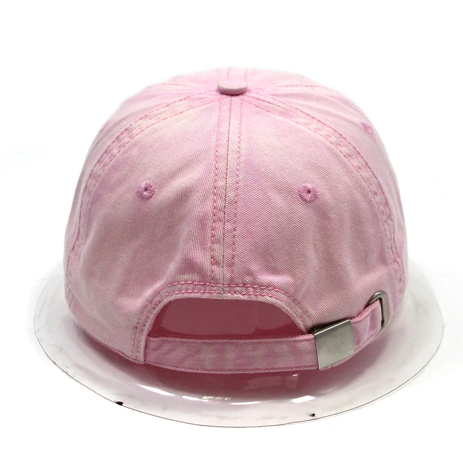 Rear view of a pink cap with an adjustable fabric strap, clasp and curved back opening.