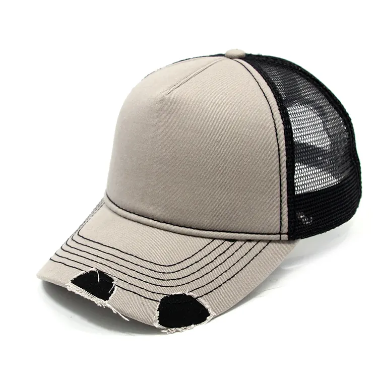 Three-quarter view of a light-front trucker cap with black mesh back, visible join line and curved cutout brim.