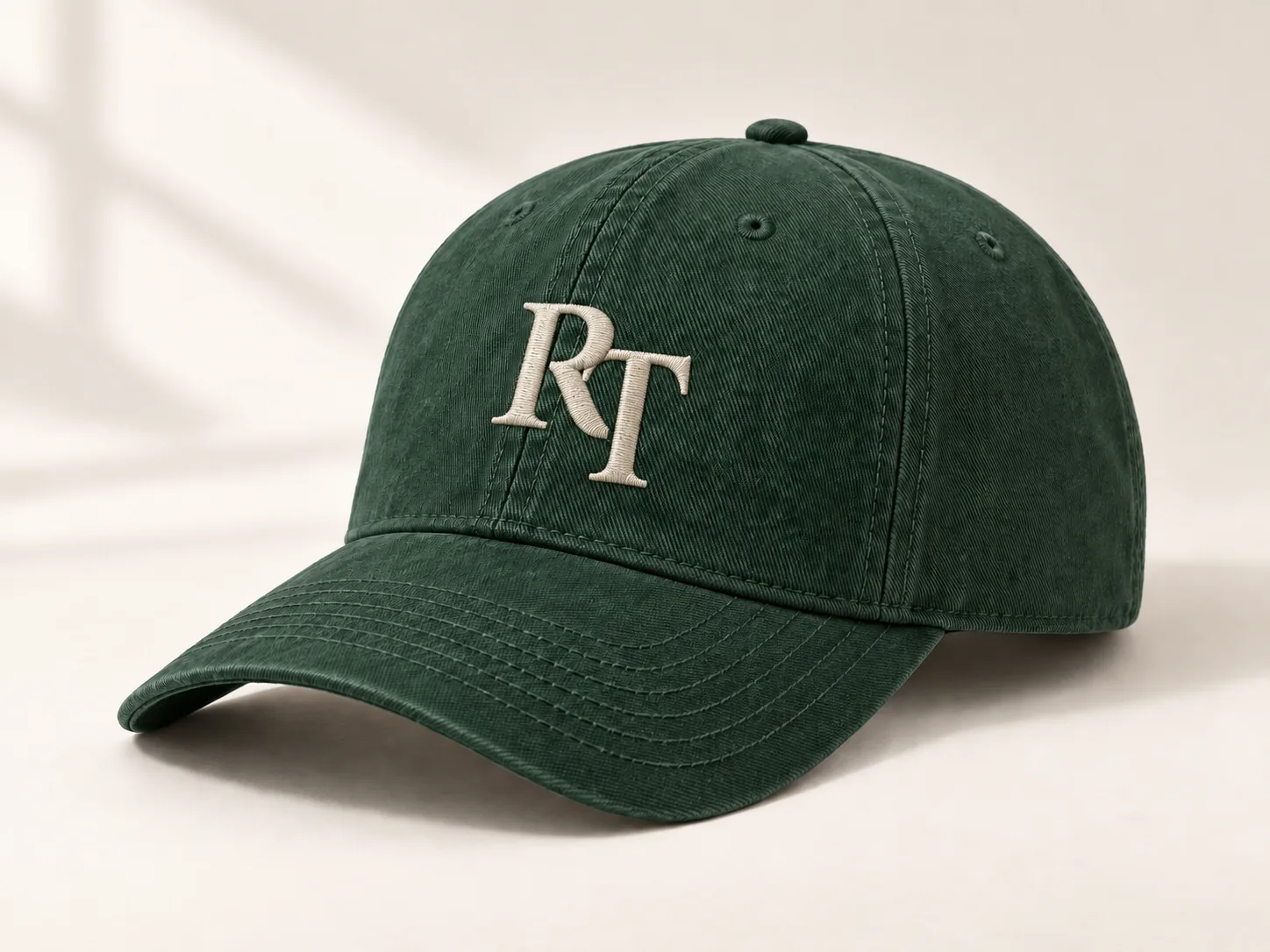 Illustrative green cap with original ivory RT embroidery