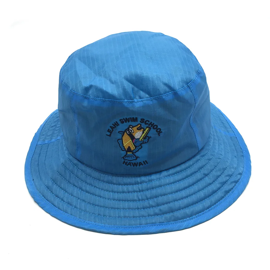 Blue bucket hat with a fish emblem and swim school embroidery on the front