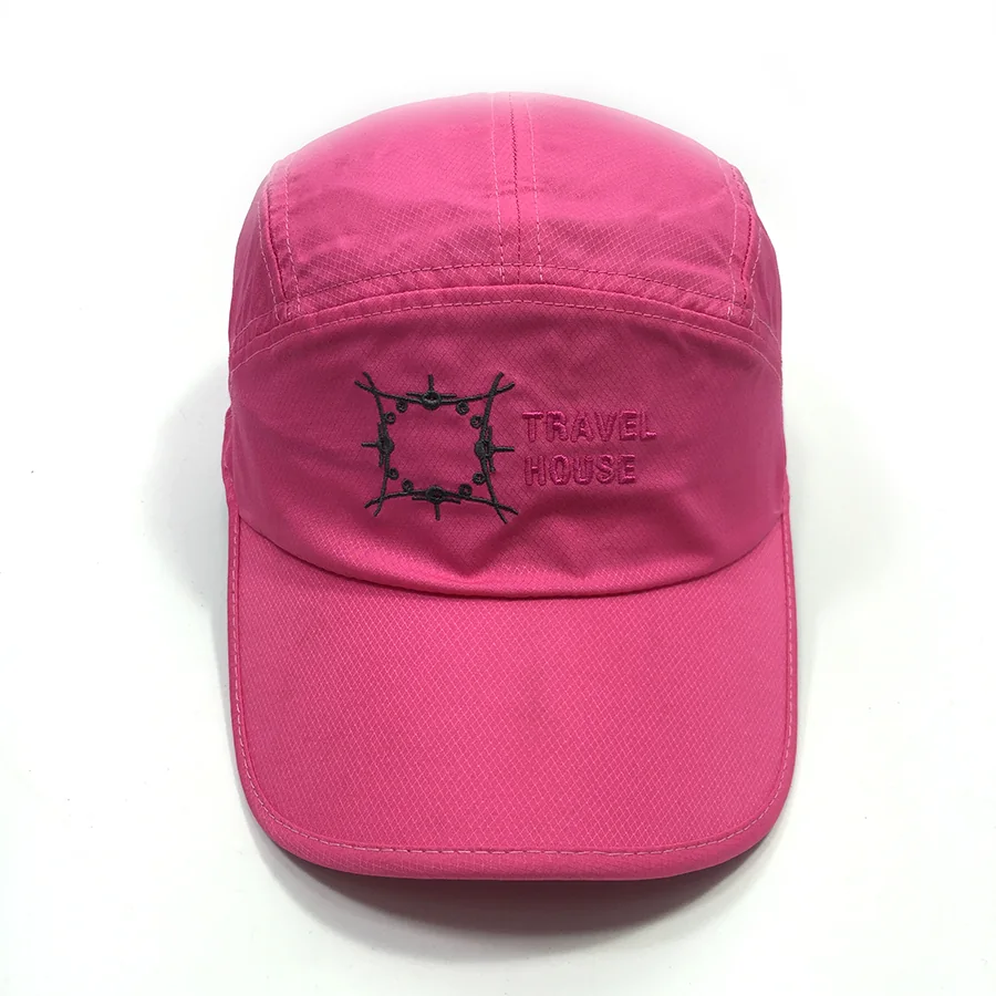 Pink sports cap with a black emblem and tonal Travel House embroidery